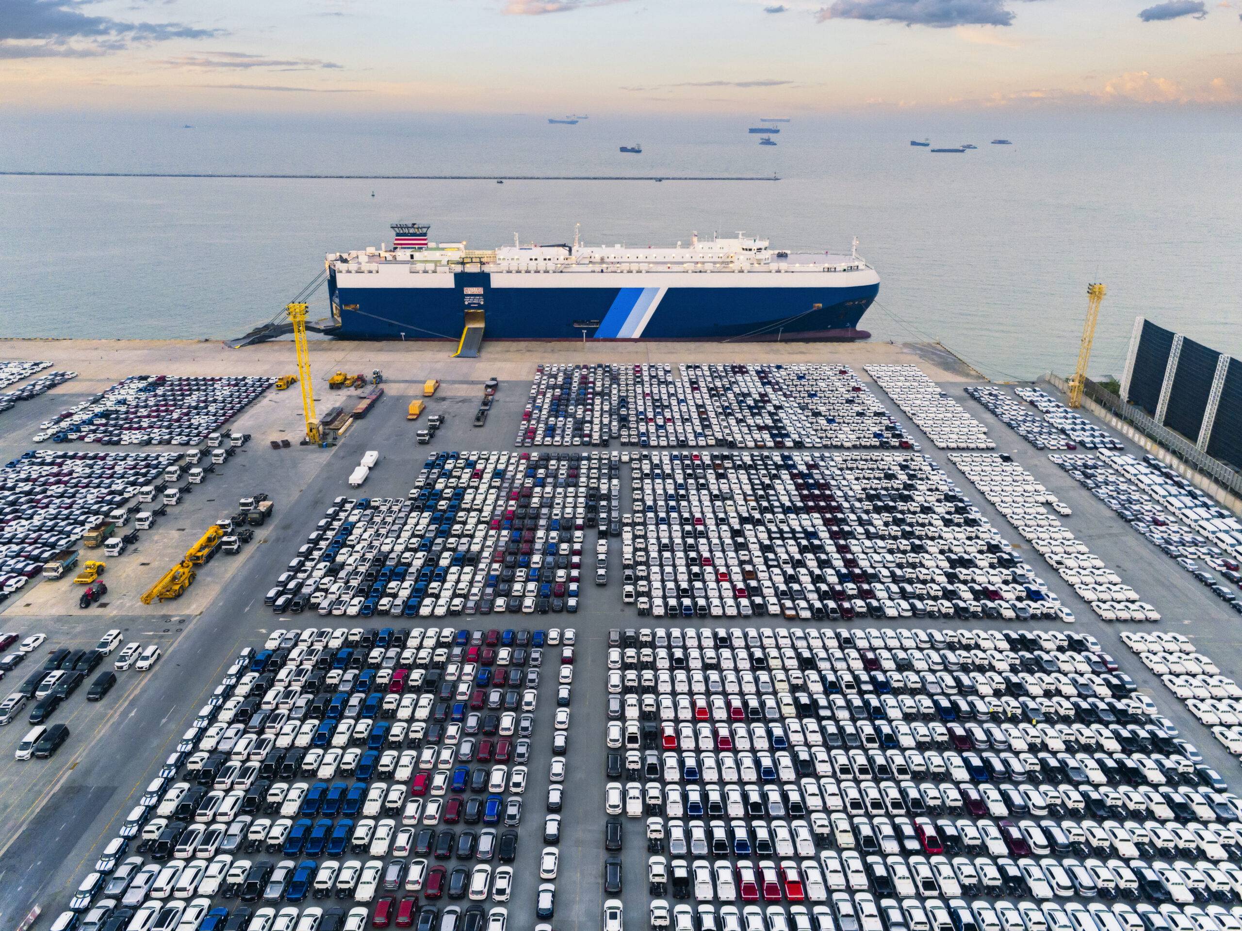 Image of a roll-on roll-off vessel in port with cars driving off the ship